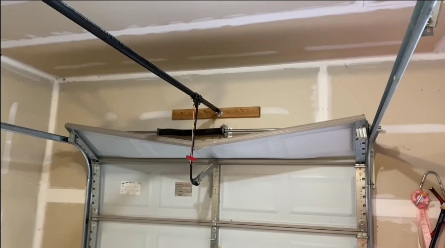 Damaged garage door before repair in Bloomington, IL